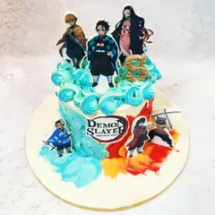 An angled view highlighting the action poses of the Demon Slayer characters and the textured, artistic frosting.