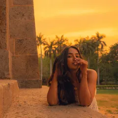 Using the architectural elements of a location to frame a portrait. The warm, glowing sky provides a beautiful, natural backdrop that complements the subject's mood.