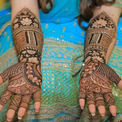 A classic, full bridal mehendi design showcasing the rich, dark stain from my 100% herbal paste. The symmetrical patterns and intricate details, including lotus motifs, are designed to adorn the bride's hands beautifully.