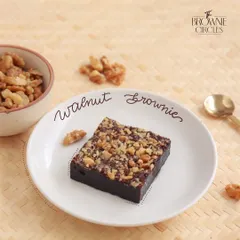Our Walnut Brownie is a timeless classic. The rich, fudgy chocolate base is generously topped with crunchy walnuts, offering a perfect balance of texture and flavor in every bite.
