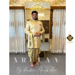 This is the classic South Indian groom's 'Muhurtam' look, made with pure silk. I designed this custom Jodhpuri-style kurta and 'kacche' (dhoti) to feel both traditional and elegant. The focus was on subtle, clean embroidery on the collar and cuffs, paired with a beautiful 'shalya' (shawl) with pure zari for that perfect ceremonial finish.