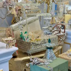 A close-up of the "Chandni Raatein" collection, highlighting the detailed acrylic and gold baskets, embellished boxes, and festive decor.