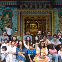 A team pauses for a group photo in front of a beautifully ornate temple during their corporate retreat in Coorg. My itineraries often blend adventure with local culture and heritage.