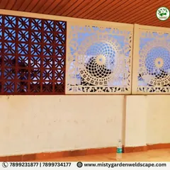 A detailed shot of the wall installation, showcasing the contrast between the dark, traditional jali brick and the light, modern CNC cut panels.