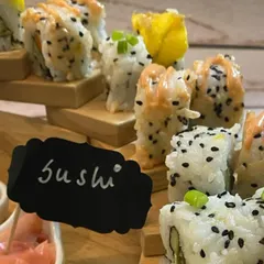 A close-up of my assorted sushi, highlighting the fresh ingredients and careful construction of each roll. The "Sushi" sign adds a charming touch to the platter.