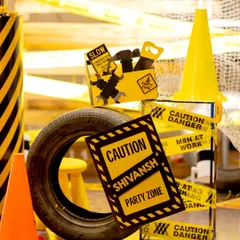 Caution: Party Zone. This vignette shows how I layer different elements like custom signs, tires, and party favor boxes to create a visually interesting and fully themed construction party environment.