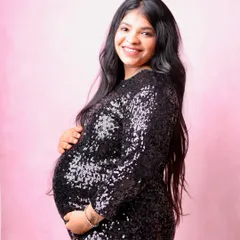 A pop of pink in the background adds a touch of softness to this glamorous shot. The black sequin dress provides a beautiful contrast and a bit of sparkle.