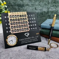 This professional mini combo set is perfect for corporate branding. It features a metal infinite calendar with a clock, a gold flake pen, and a matching keychain, all customized for "Gupta Jewellers Pvt. Ltd." with their logo and address.