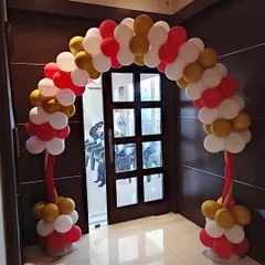 We create welcoming entrances for all kinds of family functions, including this balloon arch for a naming ceremony. The red, white, and gold color scheme provides an elegant and festive welcome for guests.