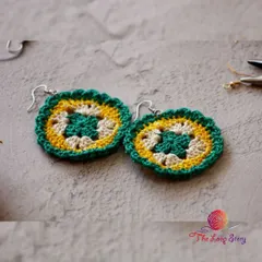 A pair of my mandala-style crochet earrings in green, yellow, and cream. These are lightweight and add a lovely bohemian touch to any outfit.