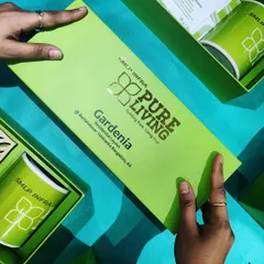 A vibrant and fully branded welcome kit for SMLP Infra. This bright green box features their logo with gold foil stamping and contains custom-printed mugs and other branded merchandise, making a bold first impression.