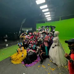 A wider shot of the cast and crew from the "Day of the Dead" shoot. Managing and choreographing for a large group of models and dancers on a green screen set requires precise coordination.