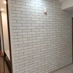 A white brick wallpaper, perfect for a clean, modern, and subtly rustic look in a hallway.