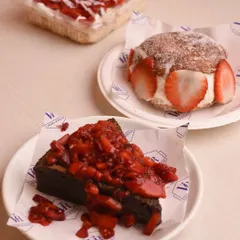 A beautiful spread from our strawberry menu, featuring the gooey brownie with strawberries, a strawberry Berliner, and our strawberry tres leches.