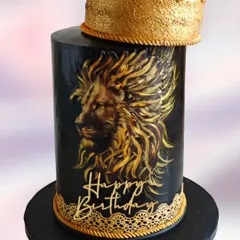 A tall and striking version of the lion theme cake. The hand-painted golden lion on a black fondant surface creates a dramatic and luxurious look for a milestone birthday.