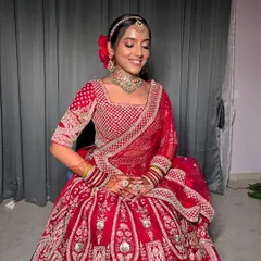 My bride Apurva looking absolutely regal in her red wedding lehenga. The look features a classic bridal updo with a red rose, defined eyes, and a flawless base that lasted through all the ceremonies.