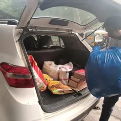 Loading my car with supplies for distribution. My social responsibility initiatives are a core part of who I am.