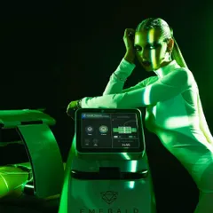 The Emerald Laser machine is a testament to advanced aesthetic science. This image shows fitness expert Deanne Pandey with the device, highlighting its status as a premier, game-changing treatment for effortless fat reduction.