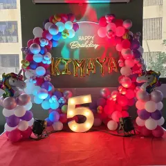 For Kimaya's 5th birthday, we created this magical unicorn theme. The setup features a vibrant balloon arch, a custom "Happy Birthday" neon sign, and a large light-up number '5' that became a centerpiece for photos. It’s these details that make a party unforgettable.