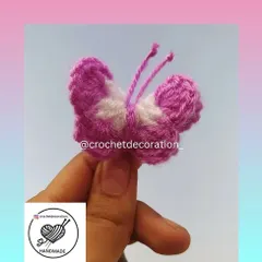 A closer look at our handmade crochet butterfly charm. The fuzzy texture and simple design make it a sweet and subtle accessory.