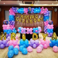 A Frozen-themed naming ceremony decoration with a pink and blue color scheme and 'Naming Ceremony' foil balloons.