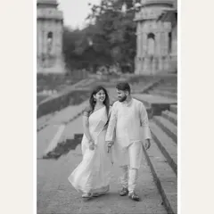 A black and white version of the couple walking at Banganga Tank. This edit gives the photo a timeless, classic feel, emphasizing the heritage of the location and the eternal nature of their bond.