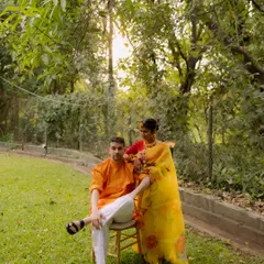 A stylish couple portrait taken in a lush garden setting. The composition and natural light highlight the couple's elegance during their Haldi ceremony at Oleander Farms.