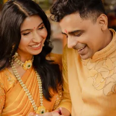 A vibrant yellow kurta with delicate, tonal embroidery for a Haldi ceremony. The design complements his bride's attire, creating a perfectly coordinated and joyful look for the celebration.
