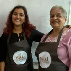 Posing with Vimala ma'am, wearing our Mitti Matters aprons. These workshops are built on the support of a strong, empowering community.
