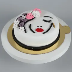 This artistic cake features a beautifully crafted woman's face made from fondant and icing. It's a unique and personal cake perfect for celebrating a special woman in your life, be it for a birthday or anniversary.