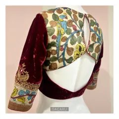 The perfect amalgamation of Indian fabrics and techniques. We juxtaposed hand-painted Kalamkari fabric and rich maroon velvet, finishing it with delicate hand embroidery.