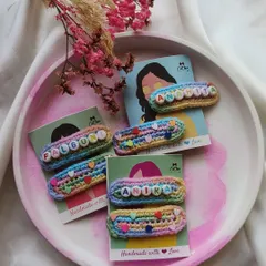 Our personalized name clips are one of our most-loved creations. We handcraft each one with colorful crochet yarn and letter beads to make a truly unique accessory for your little one.