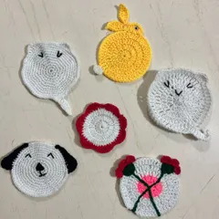 A set of whimsical, custom-made tea coasters featuring cute animal faces like cats and a dog, alongside a bunny and floral designs.