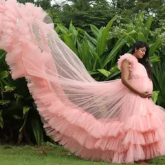 A side view of the pink maternity gown, showcasing the beautiful cascade of ruffles.