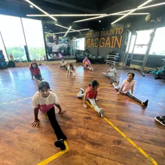 Our Kids Jazz class working on their middle splits. We guide students through flexibility training safely, helping them achieve their goals step by step.