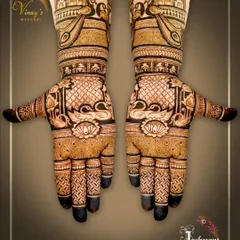 A beautiful designer mehndi with swans on the palms and palace architecture on the arms. The fingertips are left dark for a classic look.