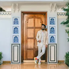 The complete look, paired with colorful sneakers, shows how to inject personality into a traditional outfit. This is modern groom style at its best.