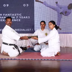 The moment a student receives their Kuro Obi is a sacred tradition. Here, I present a Shodan black belt, recognizing the culmination of years of hard work and perseverance.