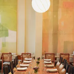 A beautifully set long table at our Malcha Marg cafe, ready for a private dinner. The warm lighting and elegant decor create a special atmosphere for any event.