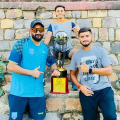 The coaching team celebrating with the trophy. A proud moment for all of us.