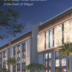 A night view of the Town Hall in Siliguri, designed to be a one-stop retail landmark. The facade lighting highlights its modern architectural form, creating an inviting presence in the heart of the city.