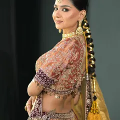 A traditional Punjabi braid, or parandi, adds a beautiful cultural touch to this bridal look. It's an elegant and timeless hairstyle that photographs beautifully.