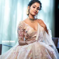 A beautiful seated portrait where the soft lighting enhances the shimmer of the sequined lehenga. This is a classic shot for any high-end fashion catalogue.