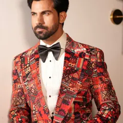 Introducing the Cantaloupe Tuxedo, a bold choice for the fashion-forward gentleman. This close-up highlights the vibrant, intricate pattern of the jacket, designed for making an unforgettable entrance.