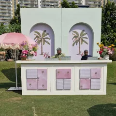 Our custom-built bar for the palm garden event. The design features a mint green arched backdrop with palm motifs and a white paneled front, perfectly matching the chic, relaxed vibe.