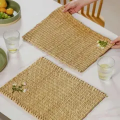 A pair of our beautifully handcrafted dining placemats made from Kauna, a natural water reed. The simple weave is accented with a small, delicate floral embroidery, adding a touch of elegance to your table setting.