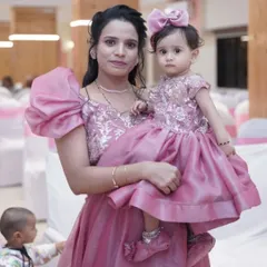 A beautiful mother-daughter duo celebrating a birthday. This matching pink gown set with embroidered bodices and puff sleeves is available for rent or purchase.