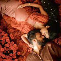 An artistic overhead shot capturing the deep connection between a couple, surrounded by a bed of flowers. A truly magical way to remember this time.