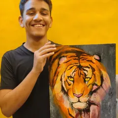 A student proudly displays his powerful tiger painting, created entirely with a palette knife. This piece showcases how to build form and intensity through textured layers of paint.