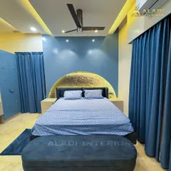 A celestial-themed bedroom with a stunning backlit full-moon headboard as the centerpiece. The deep blue walls and matching furnishings create a dreamy and tranquil atmosphere, perfect for restful nights.